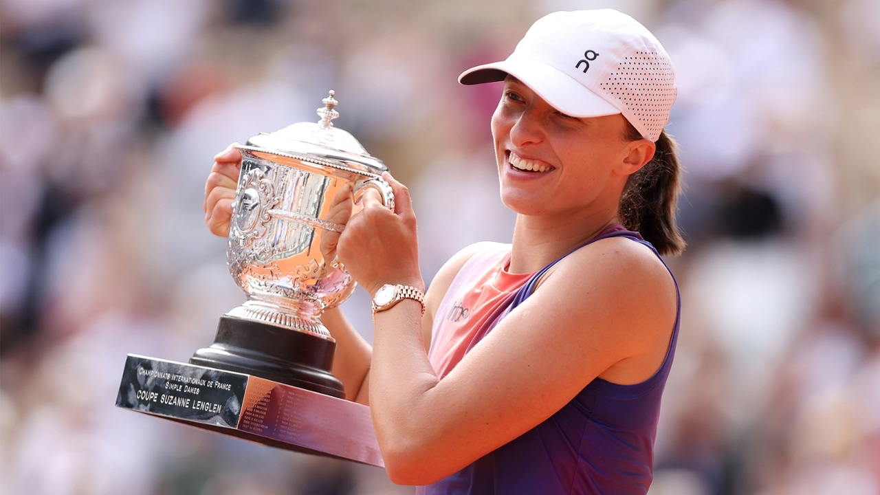 Iga Swiatek celebrating with a trophy in 2026 season potential